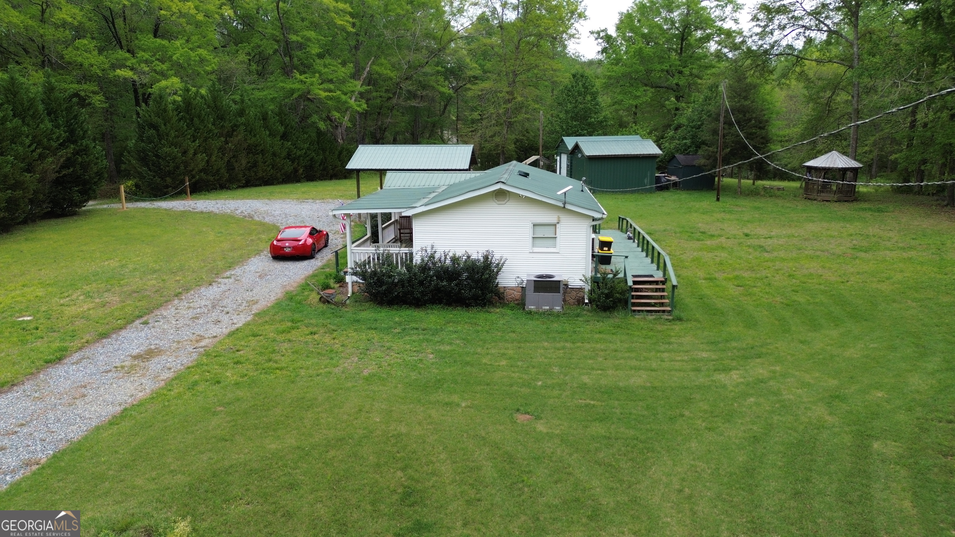 969 Flowers Road Molena, GA 30258 - Photo 9 of 16 a view of a house with a yard and sitting area