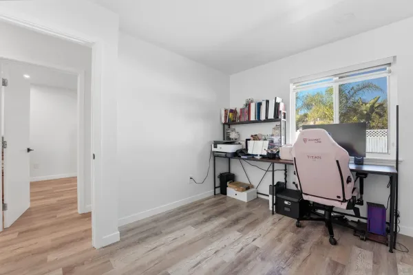 a view of workspace with wooden floor and lounge chair