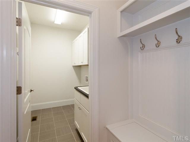 2104 East Charlotte Court Raleigh, NC 27607 - Photo 15 of 23 Mudroom off the garage entry with built-in bench seating & coat hooks. The laundry room with utility tub and tile floors. You can close the laundry door to keep the sound of drying clothes to a minimum.