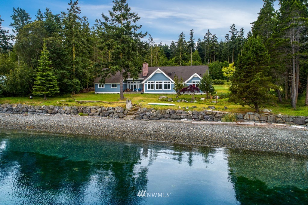 a view of house with garden space and sitting area