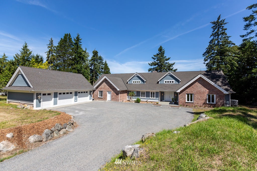 2397 Turn Point Road Friday Harbor, WA 98250 - Photo 2 of 25 a view of a big house with a big yard and potted plants in front of it