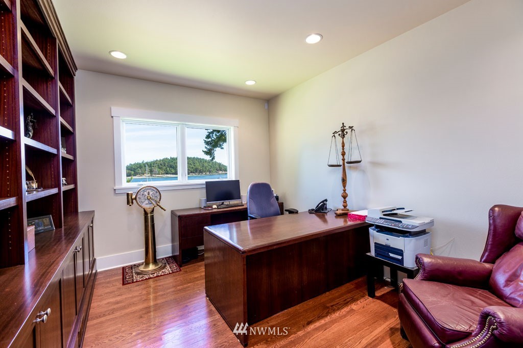 2397 Turn Point Road Friday Harbor, WA 98250 - Photo 15 of 25 a view of a workspace with furniture and a book shelf