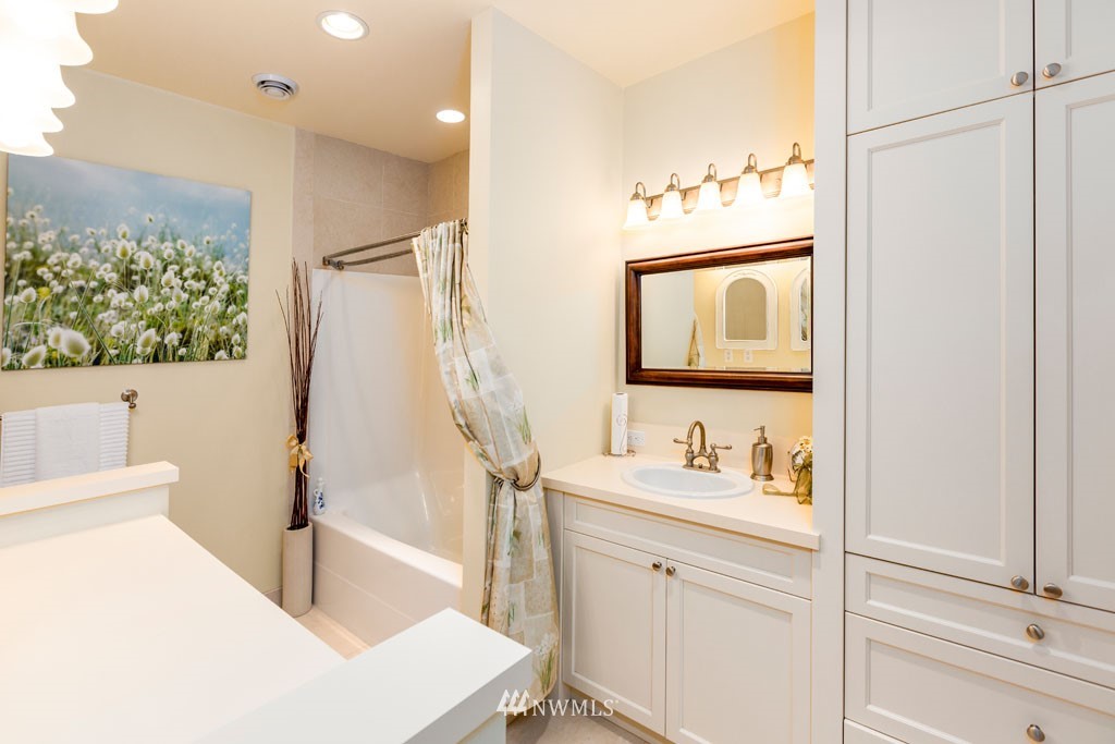 2397 Turn Point Road Friday Harbor, WA 98250 - Photo 20 of 25 a en suite bathroom with a double vanity sink a mirror and a shower
