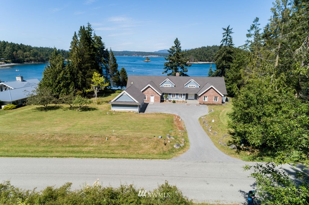 2397 Turn Point Road Friday Harbor, WA 98250 - Photo 3 of 25 an aerial view of a house with swimming pool and lake view