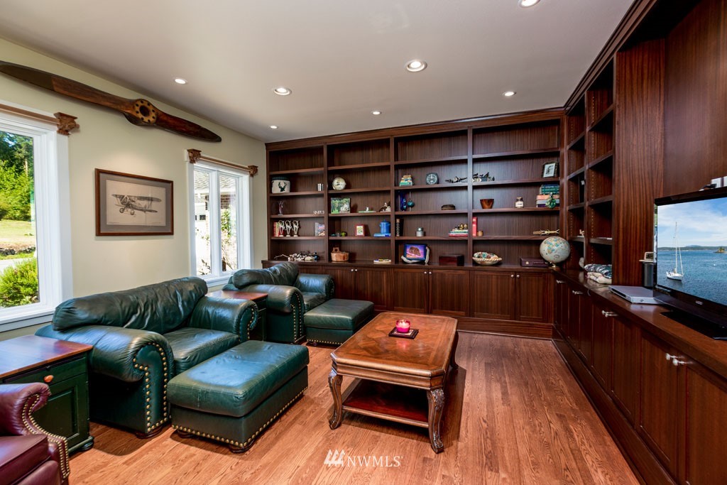2397 Turn Point Road Friday Harbor, WA 98250 - Photo 7 of 25 a living room with furniture a rug and a bookshelf