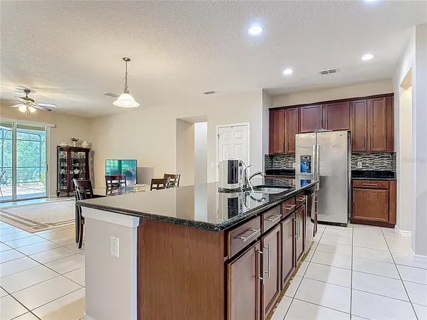 a kitchen with granite countertop stainless steel appliances and cabinets