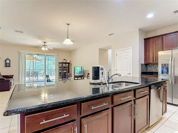 a kitchen with stainless steel appliances granite countertop a stove microwave and cabinets