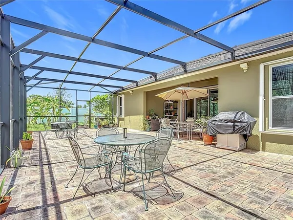 a view of a patio with table and chairs under an umbrella