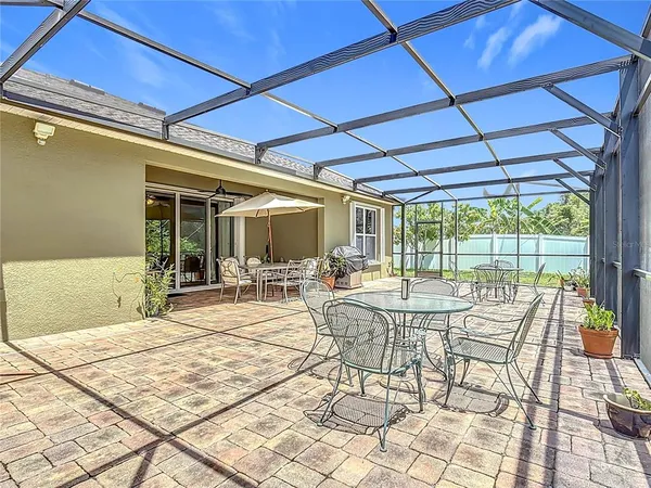 a view of a chair and tables in the back yard of the house