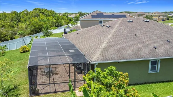 a aerial view of a house next to a yard
