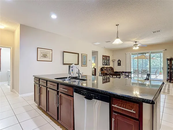 a kitchen with stainless steel appliances granite countertop a refrigerator and a stove