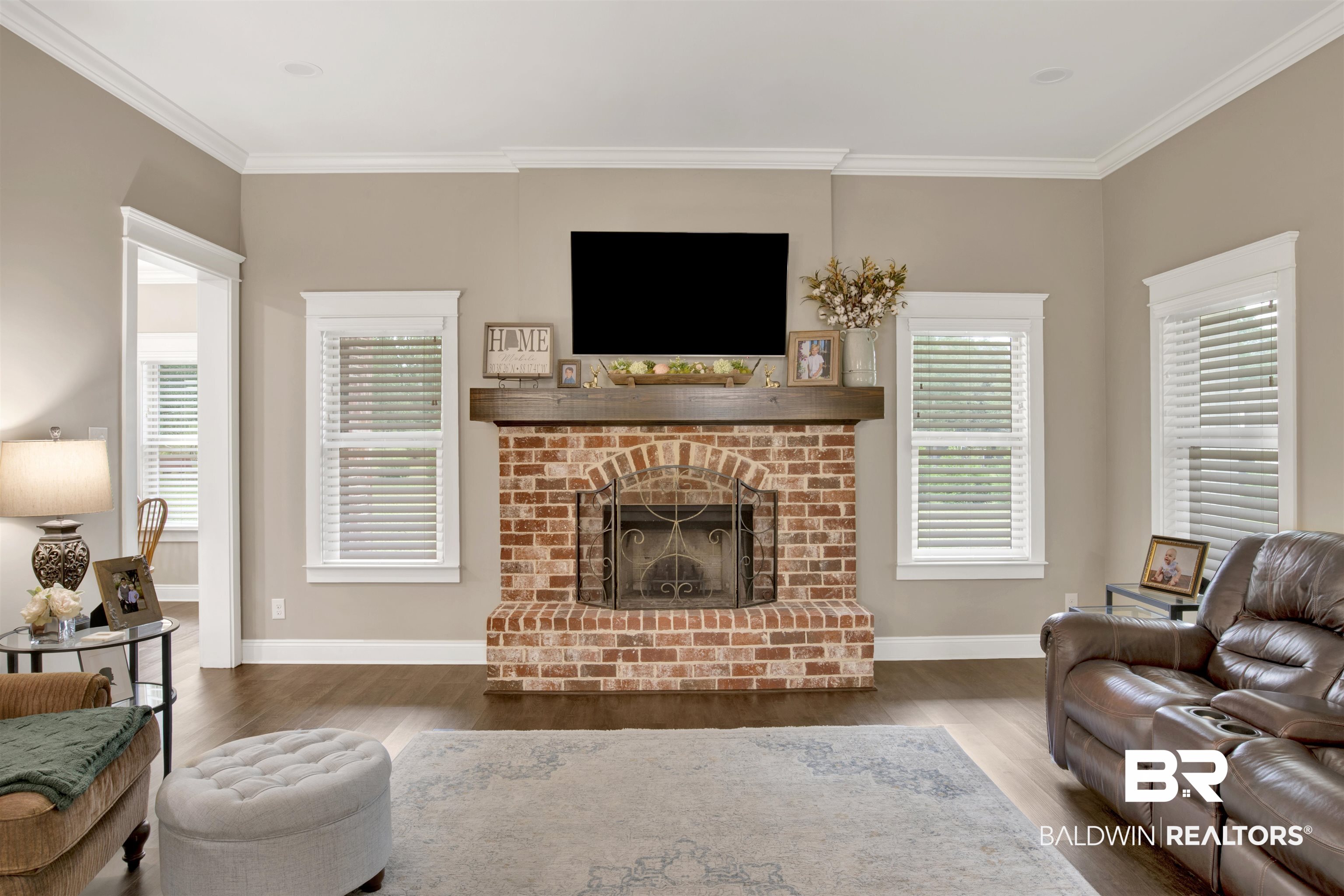 2440 Johnson Road West Mobile, AL 36695 - Photo 23 of 40 Living room featuring a fireplace, dark hardwood / wood-style floors, and crown molding