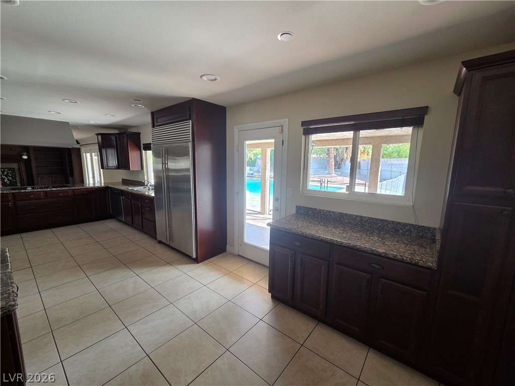 3381 Westwind Road Las Vegas, NV 89146 - Photo 19 of 52 Culinary delights await in this kitchen, boasting stainless steel appliances and easy access to the inviting pool.