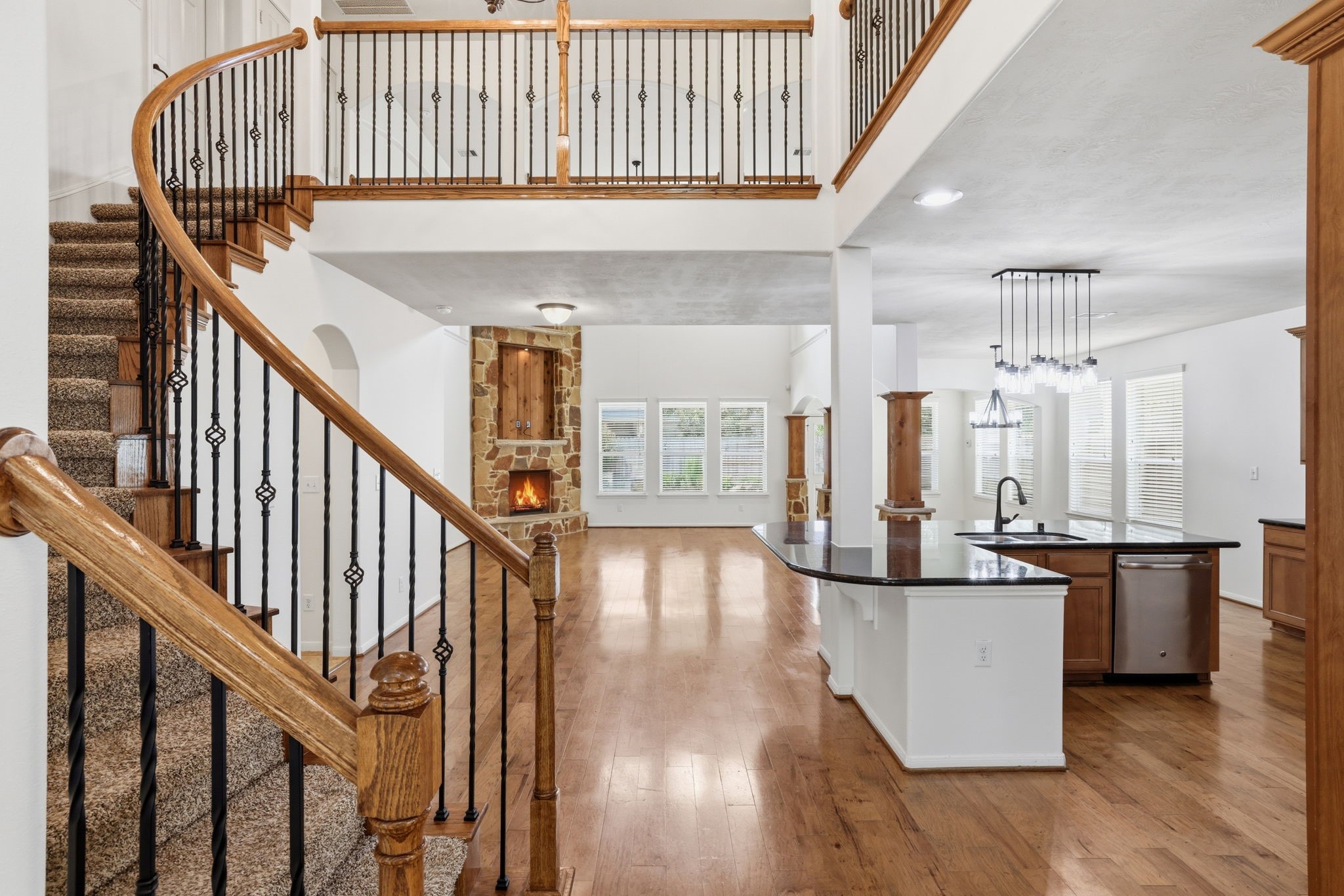 8169 Tranquil Lake Way Conroe, TX 77385 - Photo 10 of 26 a view of a hallway with wooden floor and staircase
