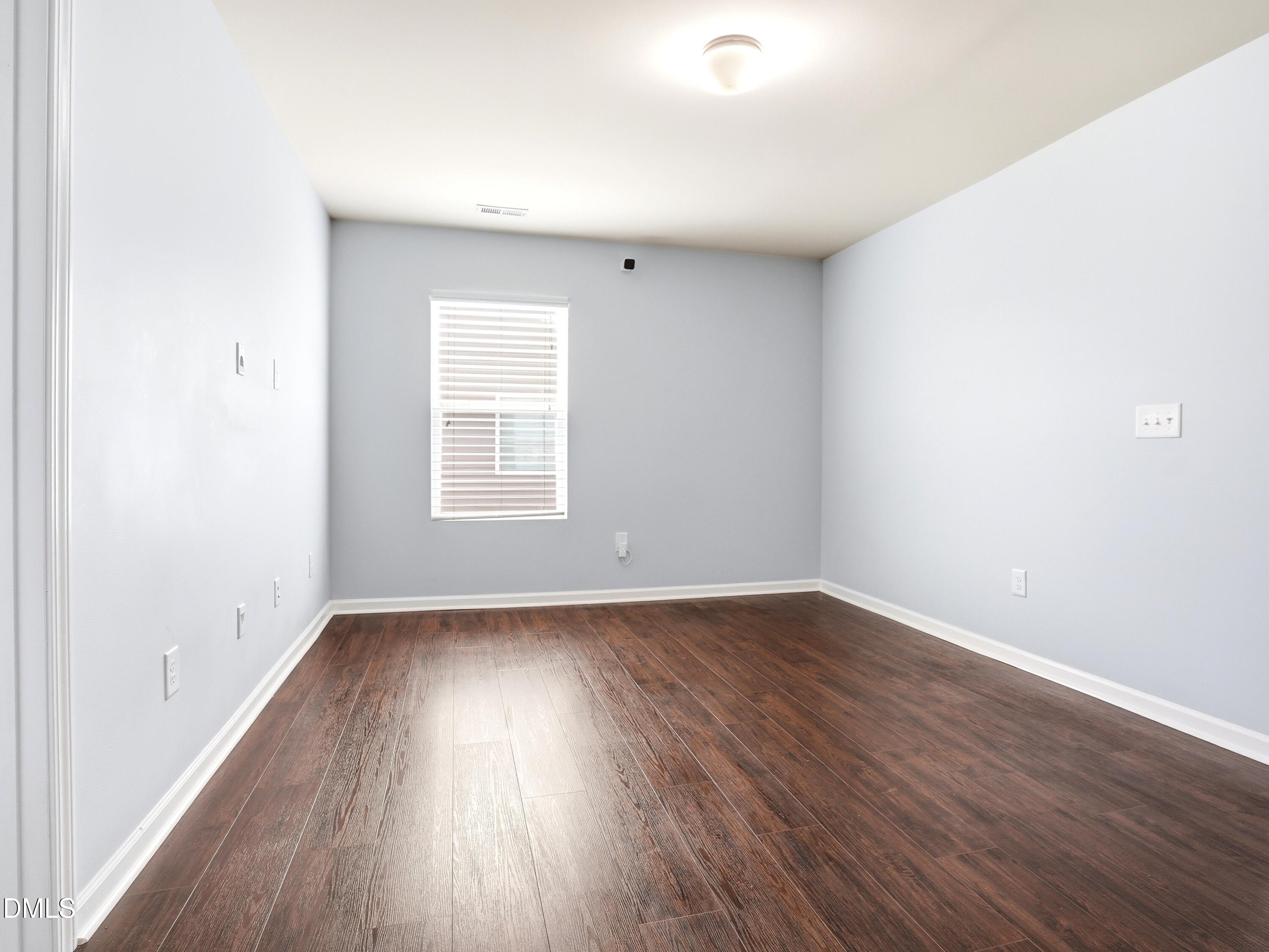 8128 Hovingham Way Raleigh, NC 27616 - Photo 23 of 40 an empty room with wooden floor and windows