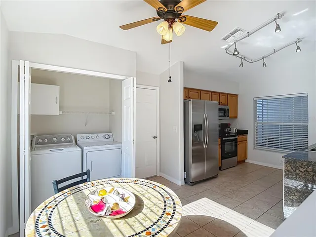 a view of kitchen with sink and refrigerator