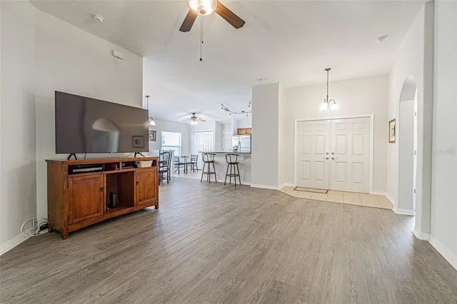 a view of a dining room with furniture and a chandelier