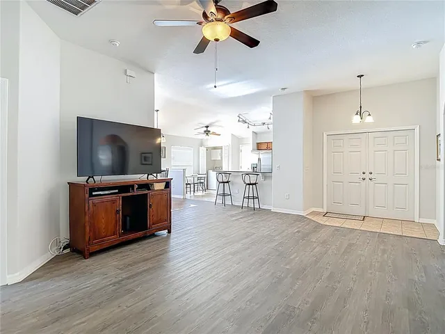 a view of a a dining room with furniture window and wooden floor