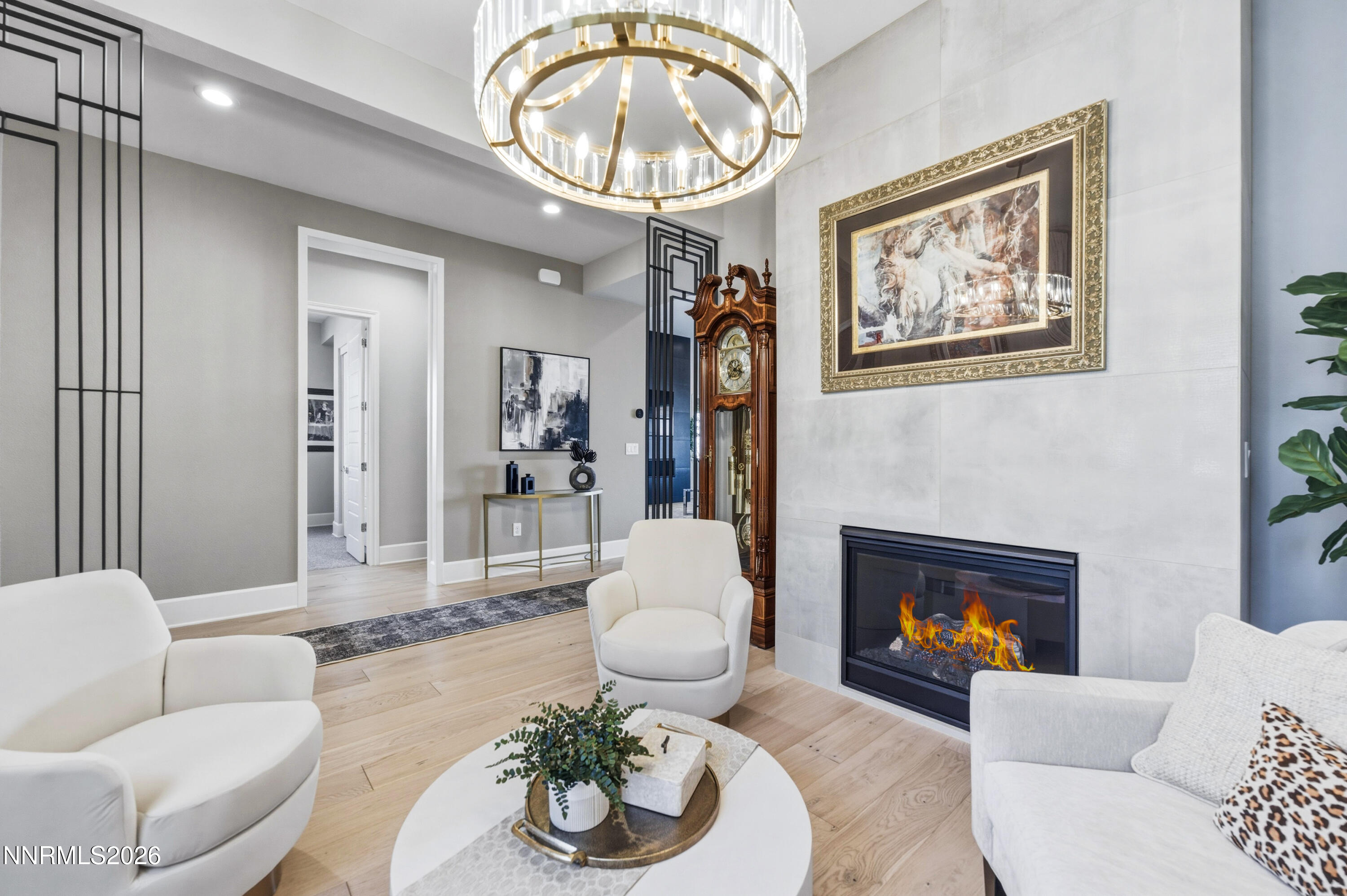 9028 Iron Sky Court Reno, NV 89523 - Photo 4 of 36 a living room with furniture a chandelier and a fireplace