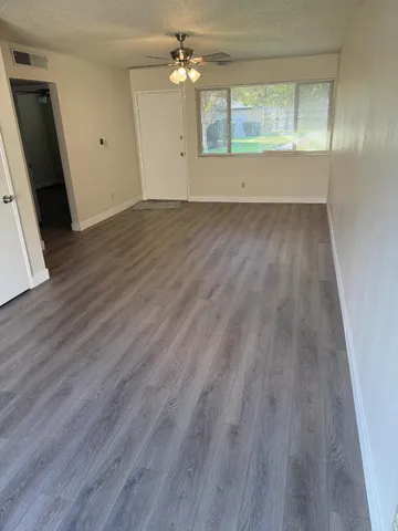 a room with a sink cabinets and a wooden floor