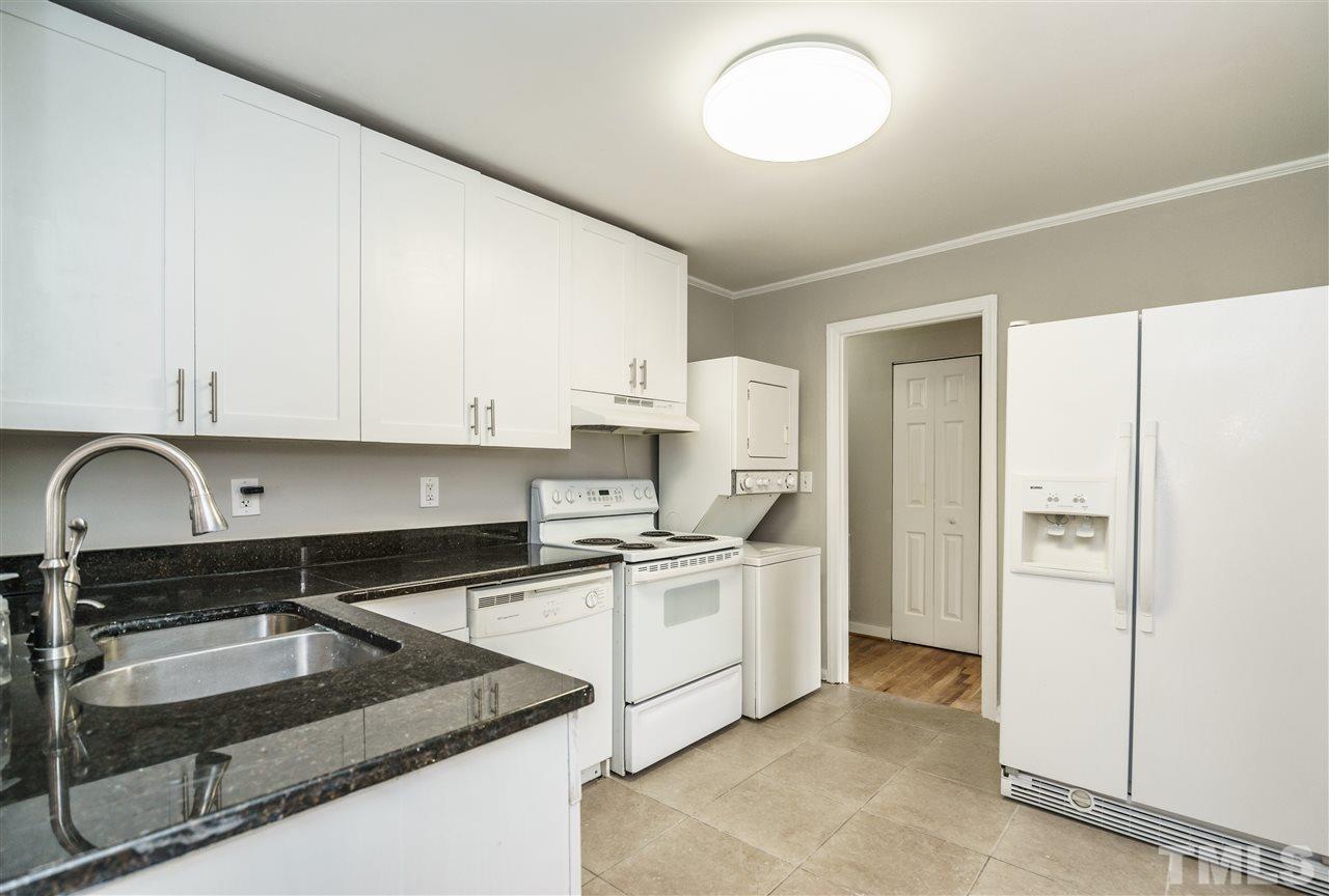 2732 Layden Street Raleigh, NC 27603 - Photo 12 of 19 a kitchen with stainless steel appliances granite countertop a sink stove and refrigerator