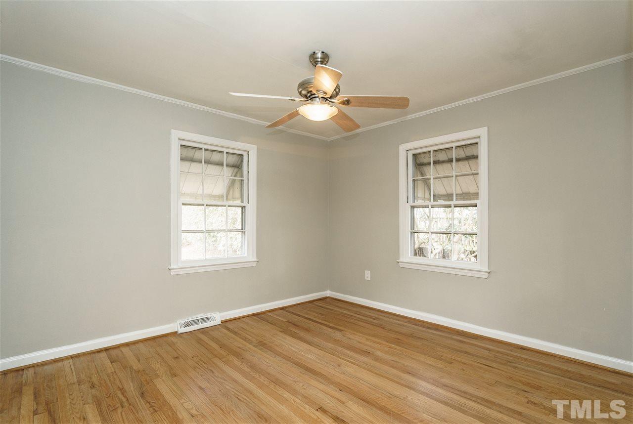 2732 Layden Street Raleigh, NC 27603 - Photo 17 of 19 a view of an empty room with wooden floor and a window