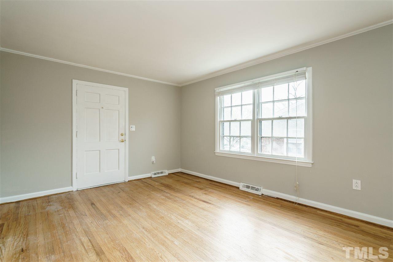 2732 Layden Street Raleigh, NC 27603 - Photo 4 of 19 an empty room with wooden floor and windows