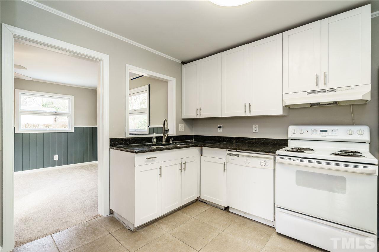 2732 Layden Street Raleigh, NC 27603 - Photo 10 of 19 a kitchen with granite countertop white cabinets and white appliances