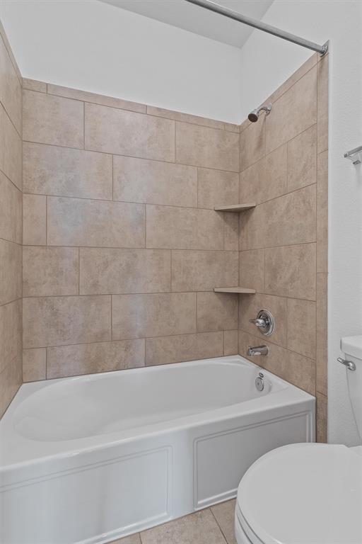 236 Prato Place Georgetown, TX 78628 - Photo 35 of 40 A well-appointed bath features a tub-shower combination with tiled walls and convenient corner shelves.