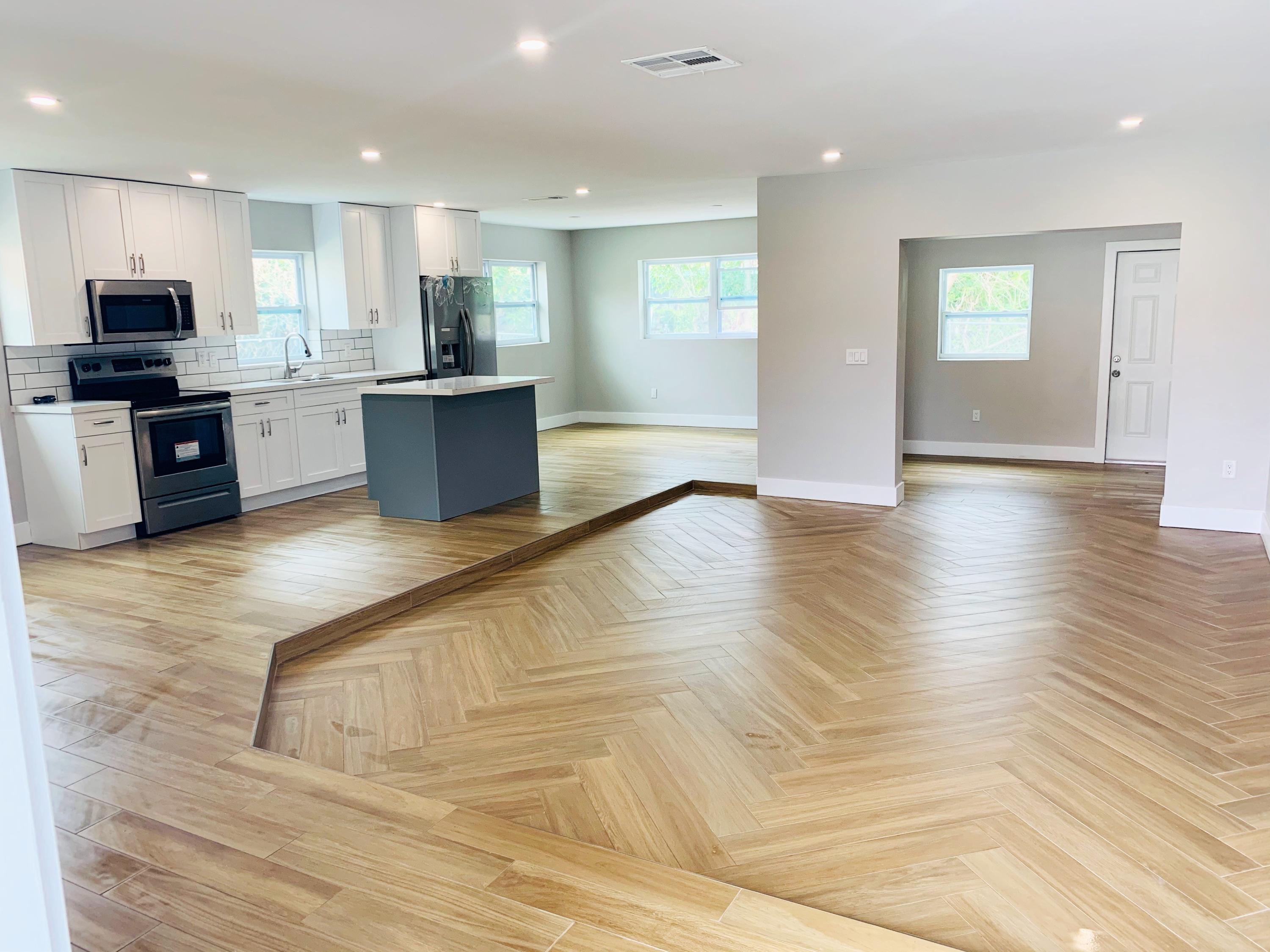 22766 Southwest 66th Avenue Boca Raton, FL 33428 - Photo 7 of 10 a kitchen with stainless steel appliances granite countertop a refrigerator and a stove top oven