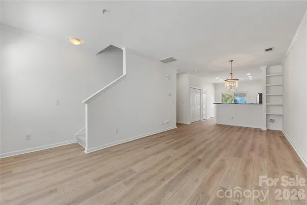 a view of a kitchen with wooden floor and a sink