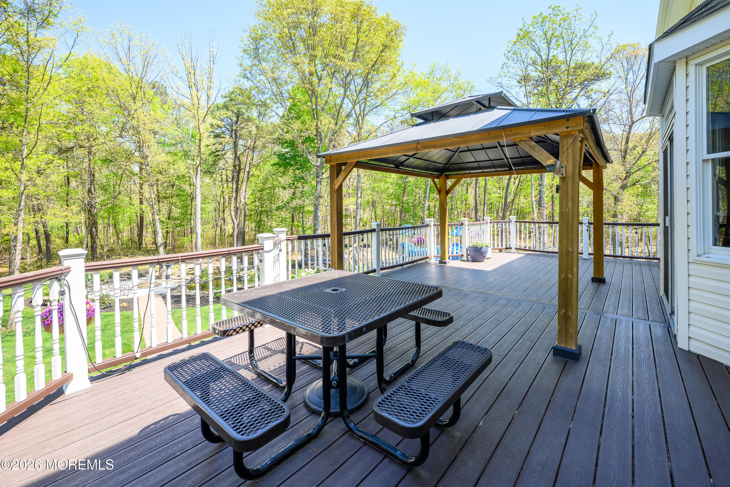 60 Partners Lane Freehold, NJ 07728 - Photo 42 of 56 a view of wooden floor with a table and chairs under an umbrella