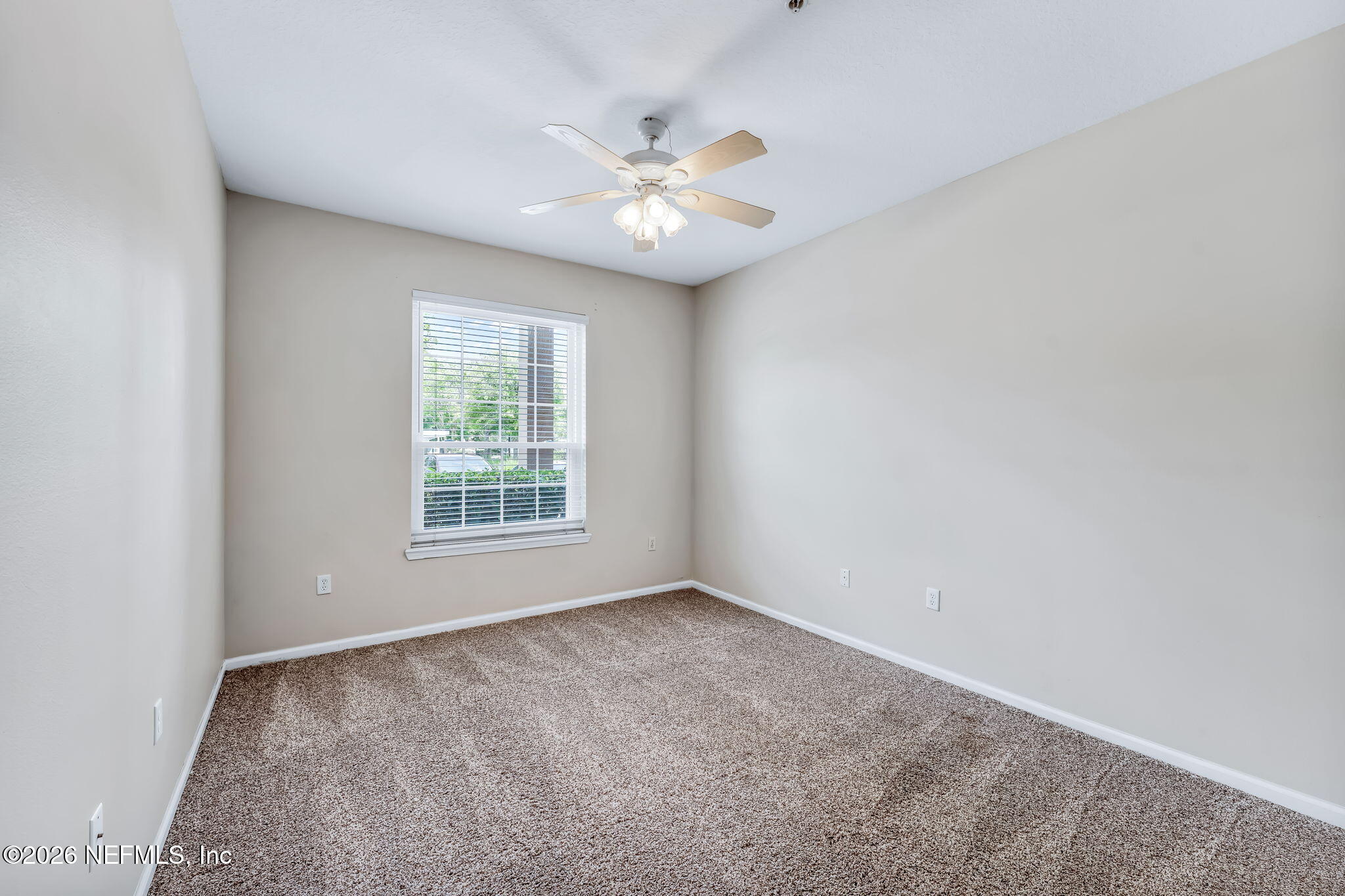 7990 Baymeadows Road East, Unit 520 Jacksonville, FL 32256 - Photo 16 of 41 a view of an empty room with window and chandelier fan