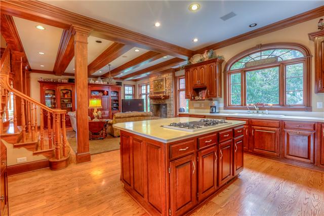 4403 Arno Road Franklin, TN 37064 - Photo 11 of 20 Kitchen with large center island surrounded by cherry cabinets. Subzero refrigerator, double oven, large pantry & Butler's Pantry that connects to Dining Room. Opens to family room & beautiful stacked stone fireplace.