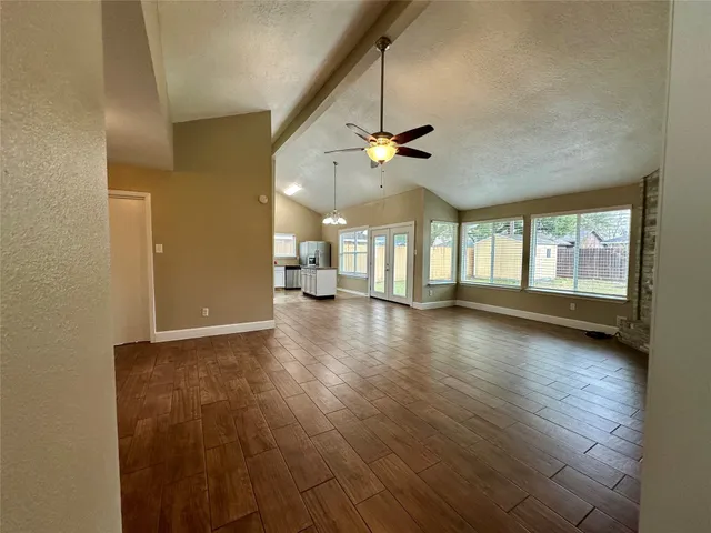 a bathroom with a granite countertop sink a mirror and a bathtub