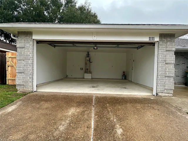 a view of empty room with brick walls