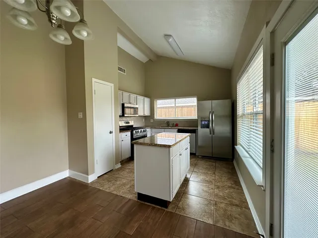 a kitchen with granite countertop a sink and a stove