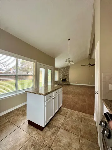a view of a livingroom with a ceiling fan and window