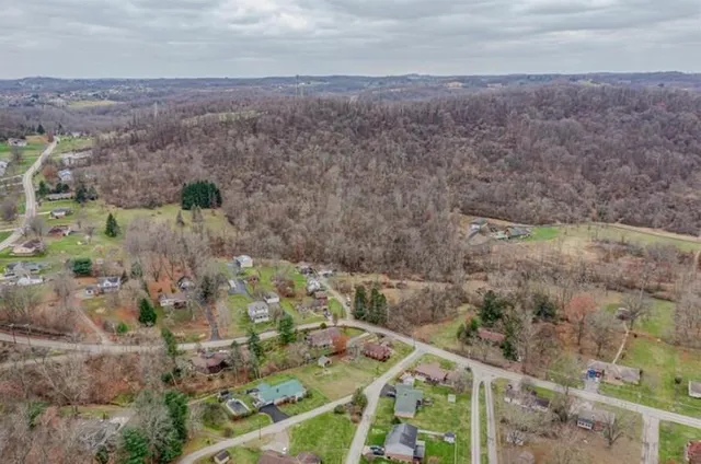 a aerial view of a house with a yard