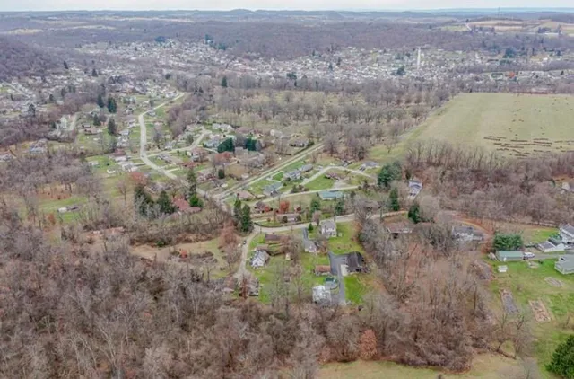 an aerial view of residential house and car parked