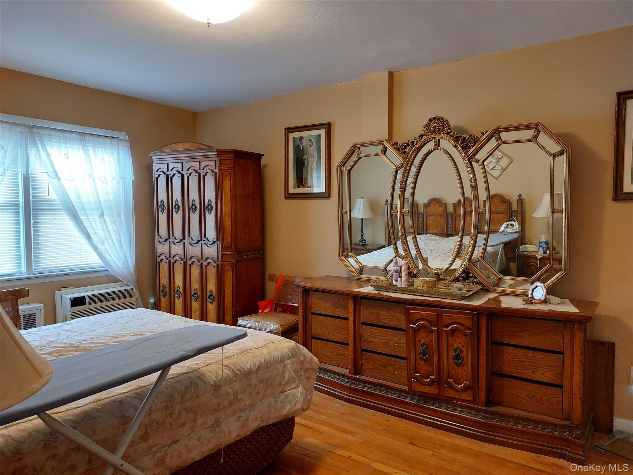 108-19 48th Avenue Queens, NY 11368 - Photo 11 of 21 Bedroom featuring light wood-style floors