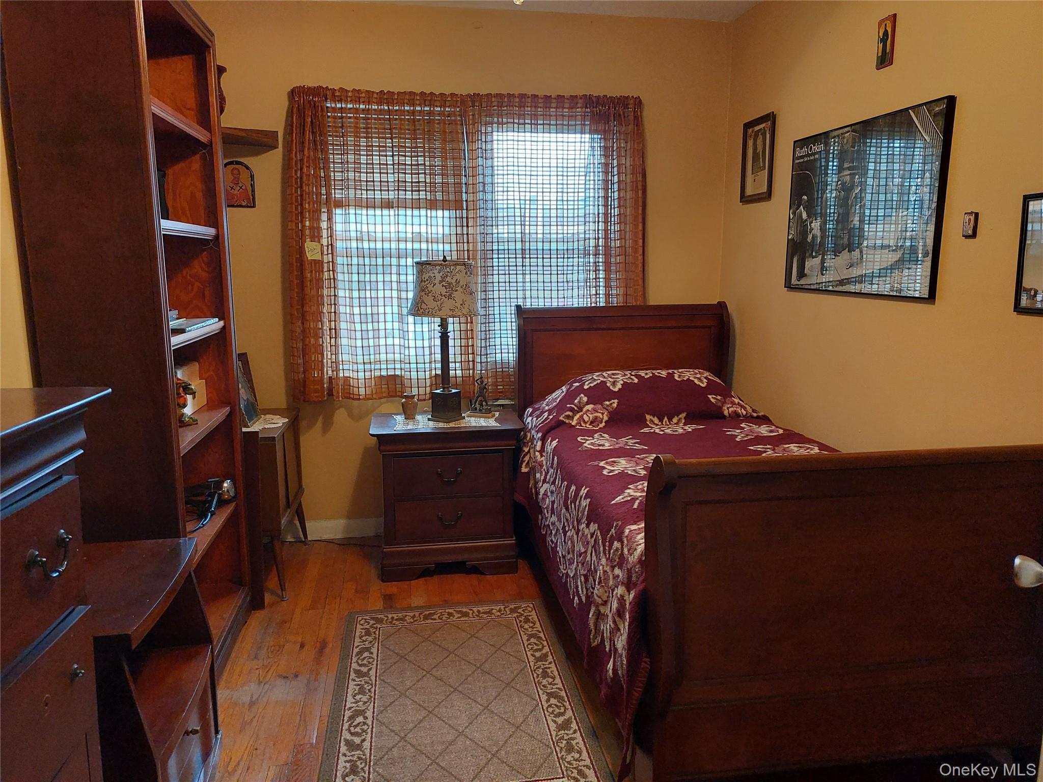 108-19 48th Avenue Queens, NY 11368 - Photo 13 of 21 Bedroom with light wood finished floors and baseboards
