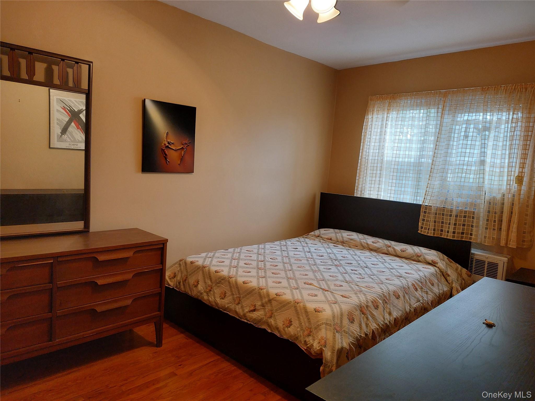 108-19 48th Avenue Queens, NY 11368 - Photo 15 of 21 Bedroom with wood finished floors