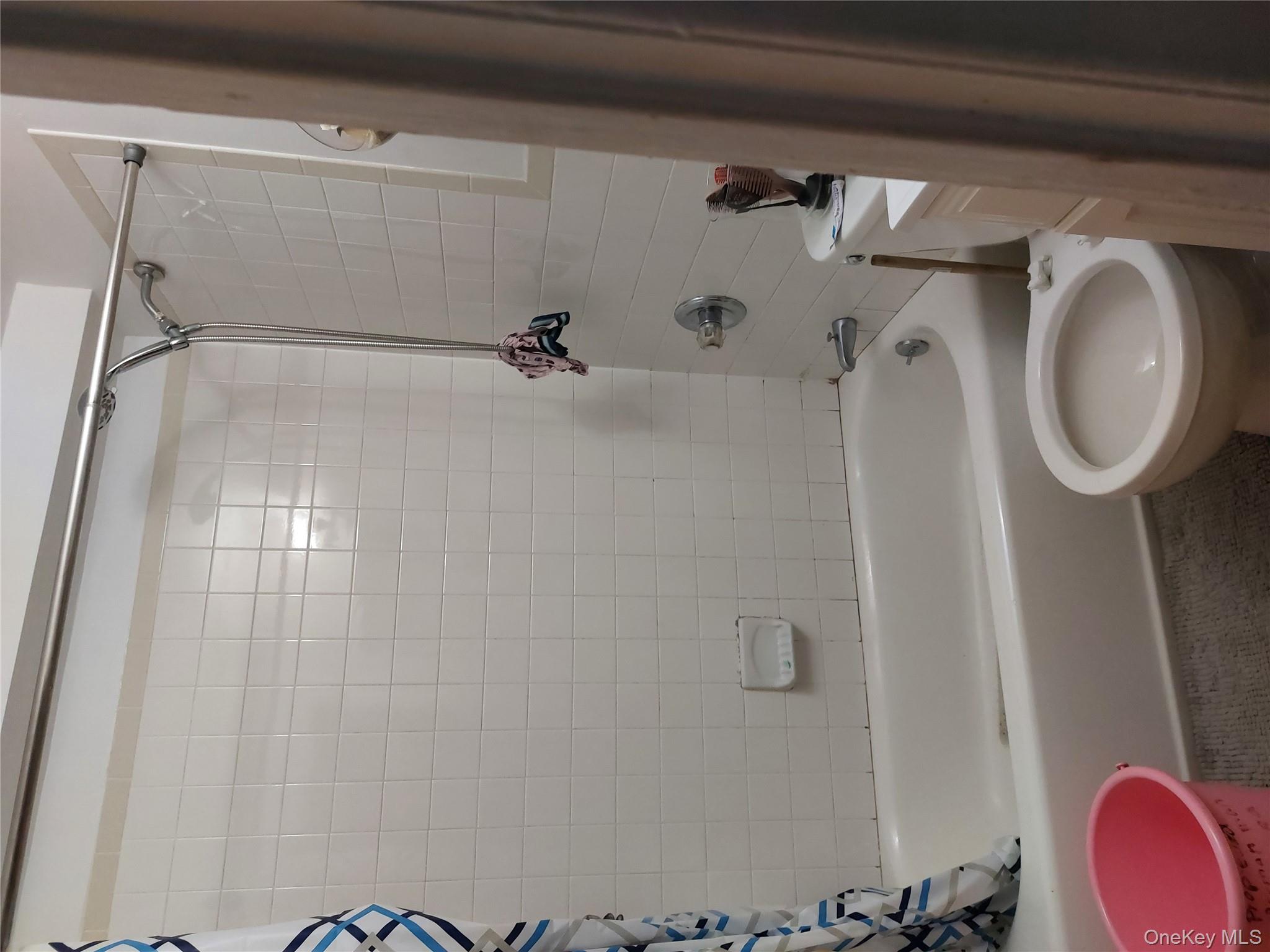 108-19 48th Avenue Queens, NY 11368 - Photo 19 of 21 Bathroom with shower / tub combo with curtain and vanity