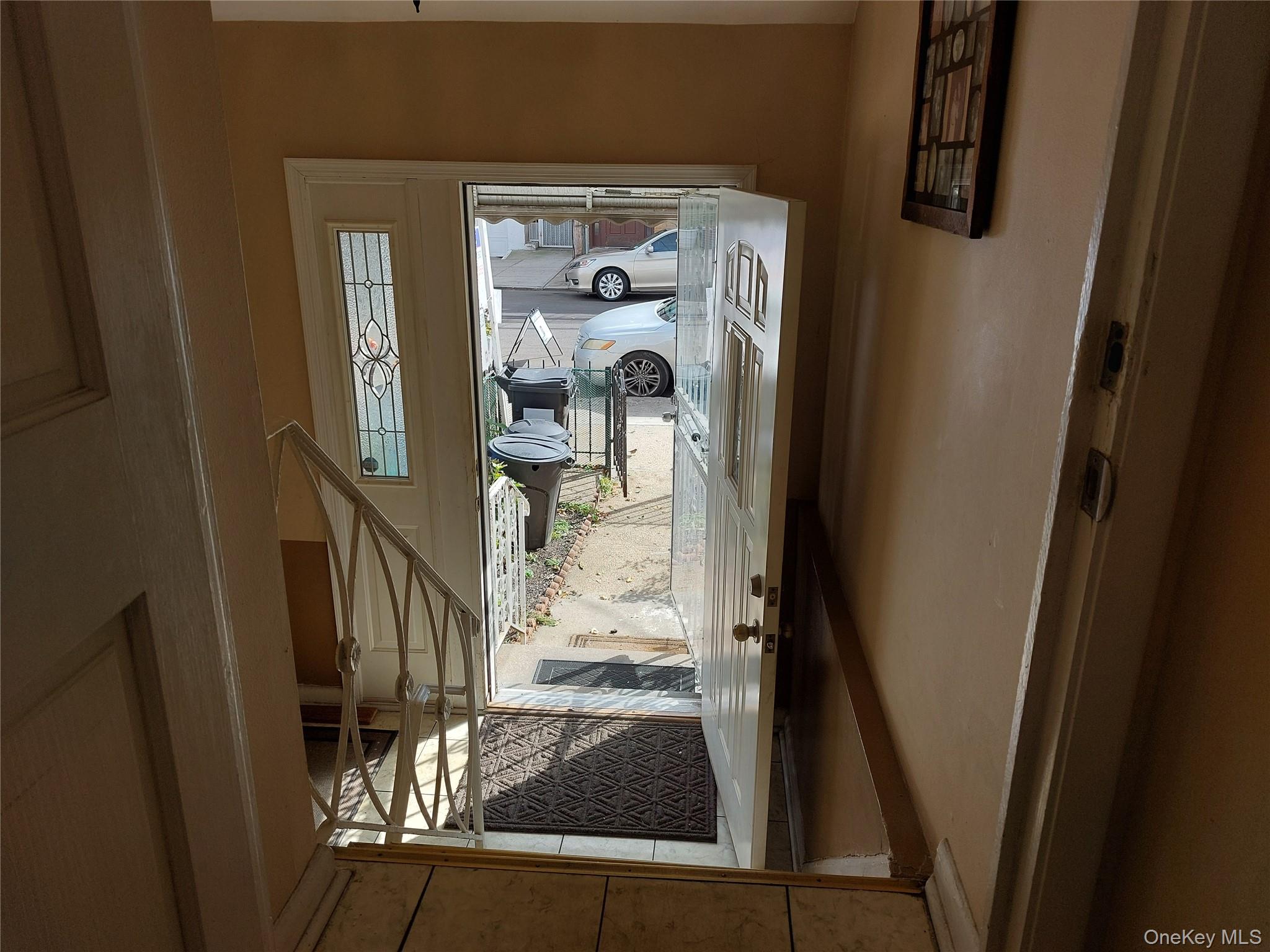 108-19 48th Avenue Queens, NY 11368 - Photo 5 of 21 Doorway featuring tile patterned floors and baseboards