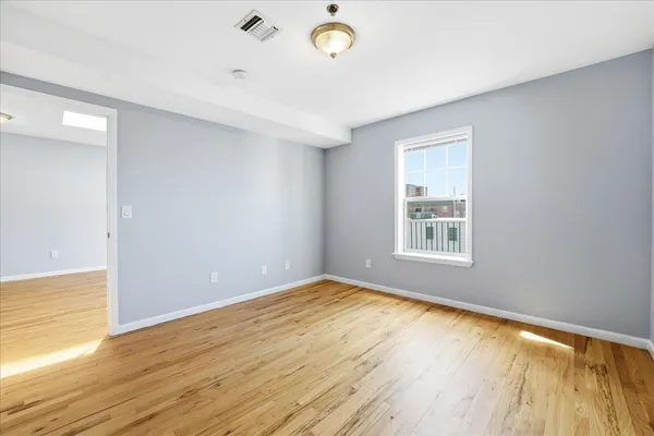 wooden floor in an empty room with a window