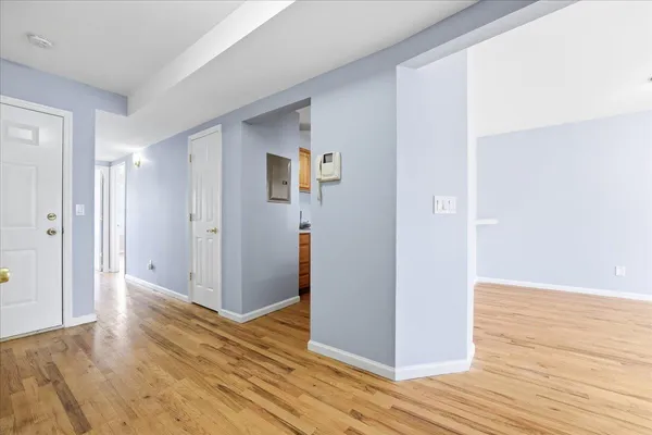 a view of a hallway with wooden floor