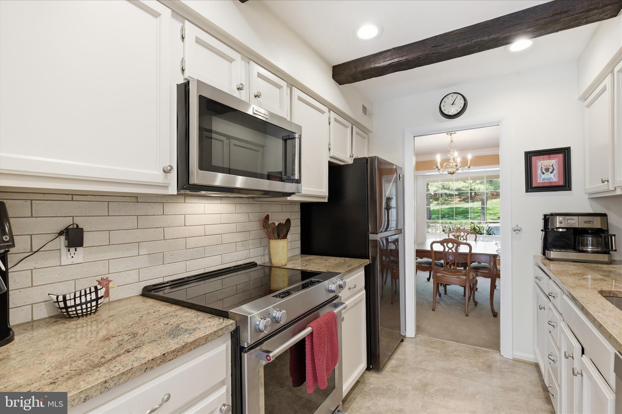 1943 Hickory Hill Lane Silver Spring, MD 20906 - Photo 15 of 54 a kitchen with a stove a sink and a microwave