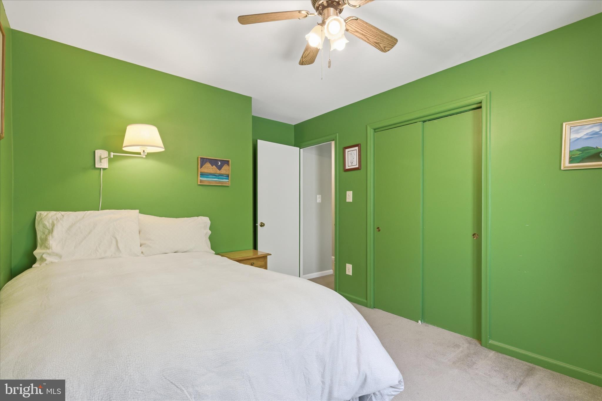 1943 Hickory Hill Lane Silver Spring, MD 20906 - Photo 35 of 54 a bedroom with a bed and a chandelier