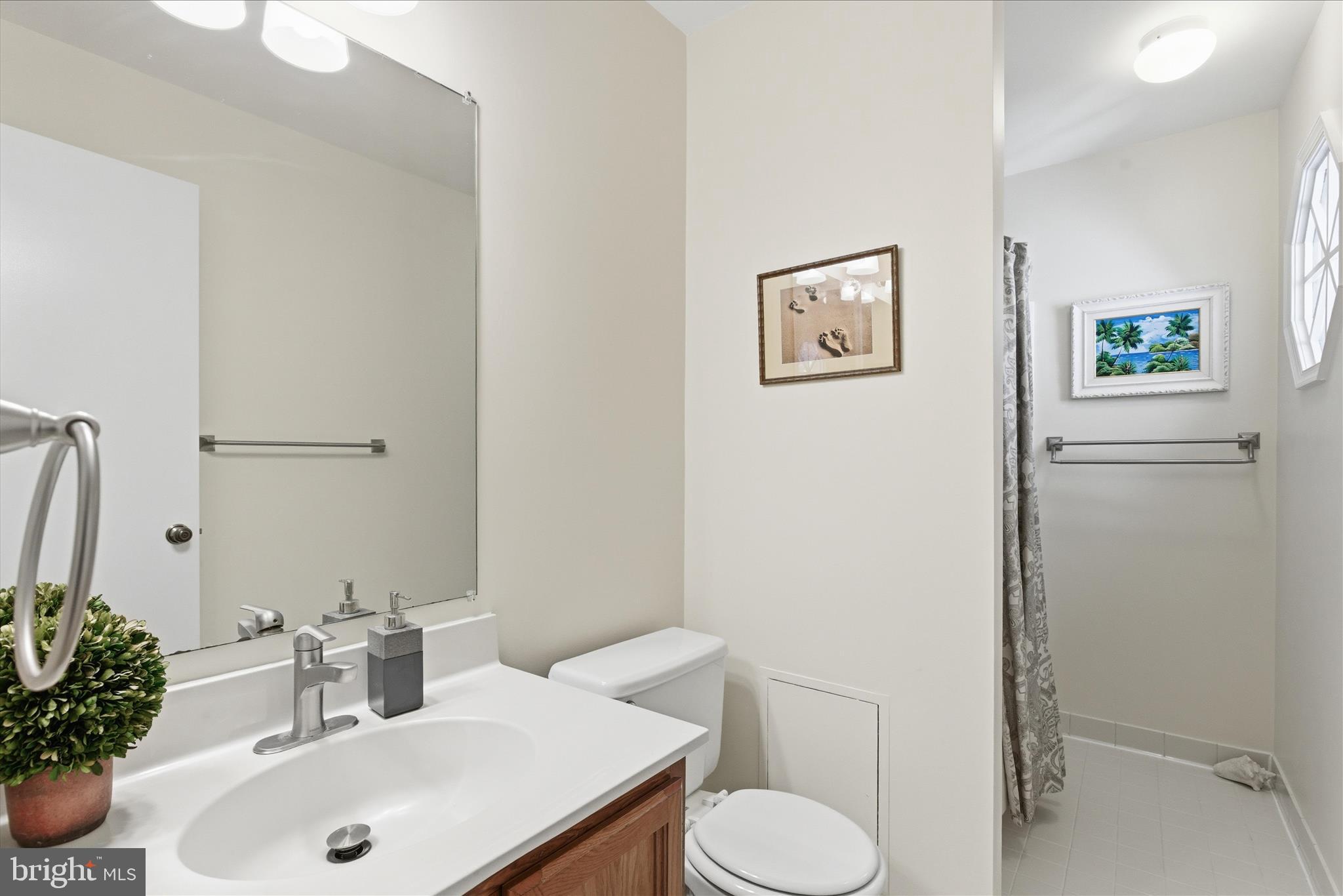 1943 Hickory Hill Lane Silver Spring, MD 20906 - Photo 37 of 54 a bathroom with a sink mirror and toilet